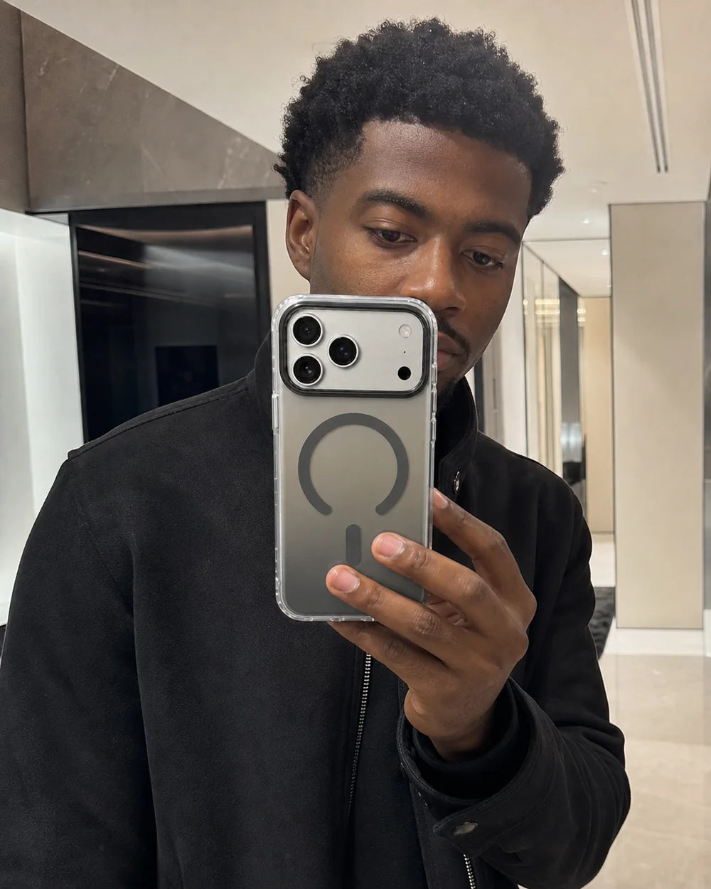 Man styling a grey Gradient MagSafe CaseBear case in a direct-flash mirror photograph