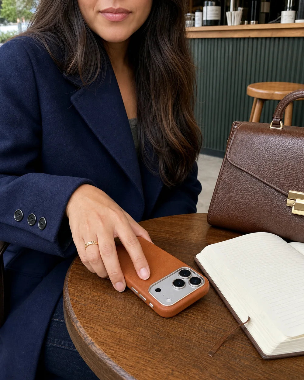 Woman with a classic-brown Leather CaseBear case, handbag and notebook at a cafe