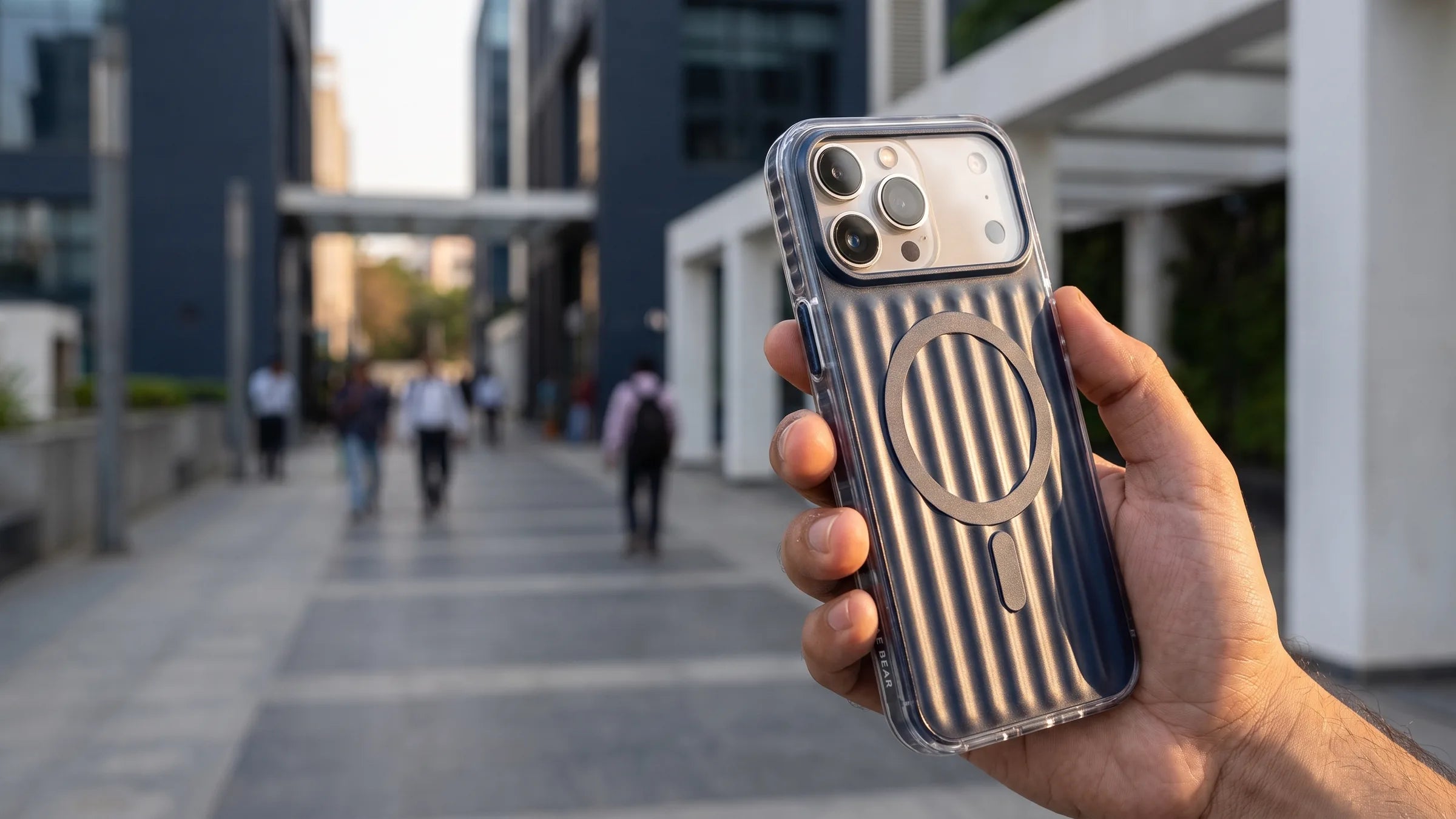 Deep-blue CaseBear Ribbed MagSafe case held securely in one hand