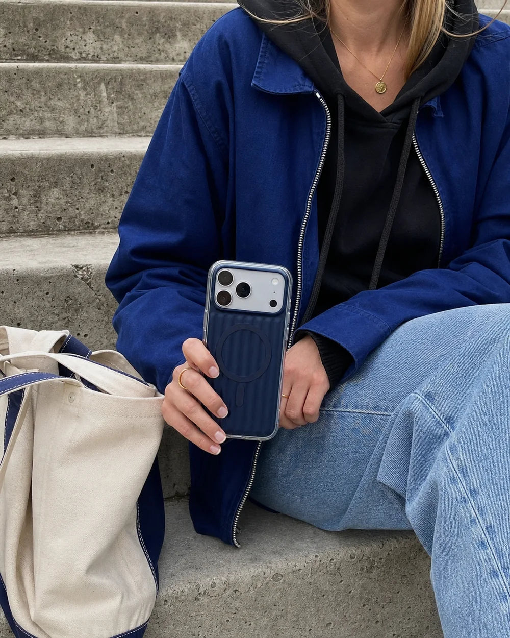 Woman pairing a deep-blue Ribbed MagSafe CaseBear case with a streetwear outfit and tote